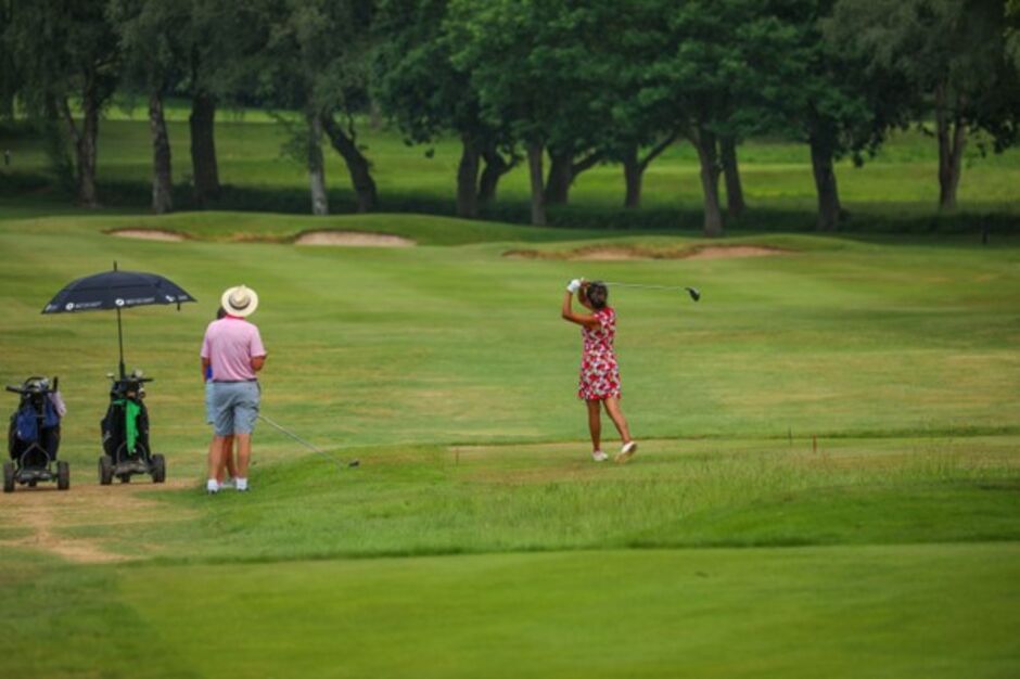 Four Golfers on a putting green